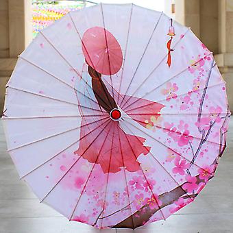 Parasol en papier blanc décoré de fleurs de cerisier roses et d’oiseaux.