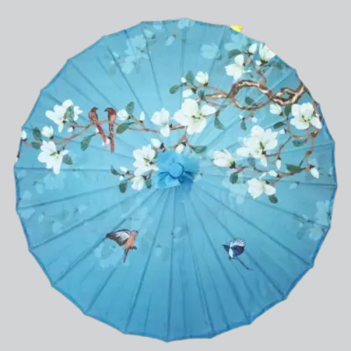 Parasol en papier turquoise décoré de fleurs de cerisier blanches et d’oiseaux.